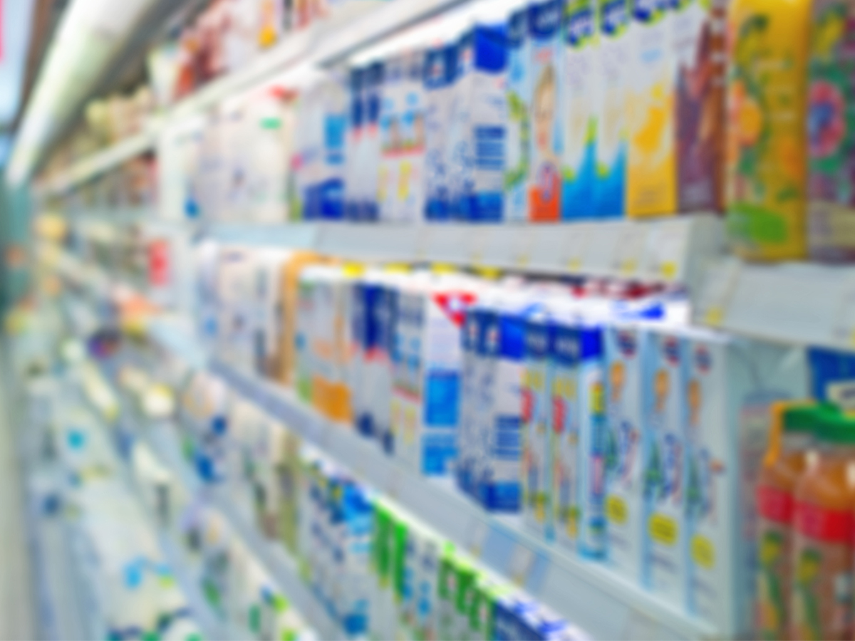 Commercial fridge in a supermarket filled with drinks.