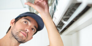 Man looking at air conditioning unit air