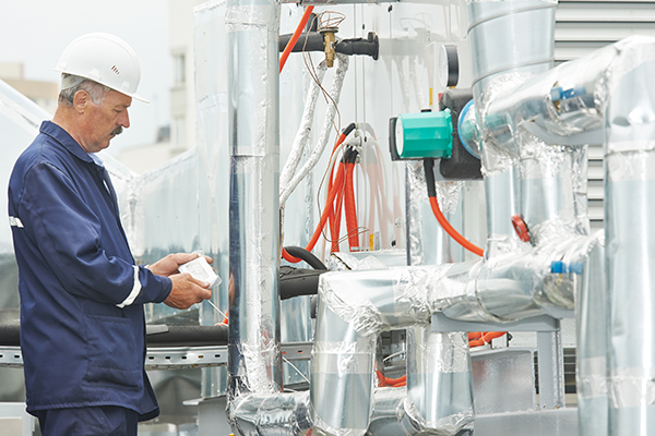 technician working on commercial HVAC system