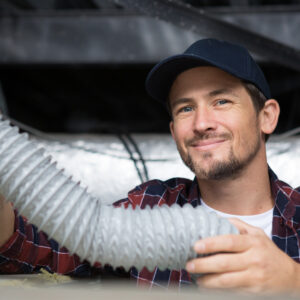 An hvac repair man holding a tube