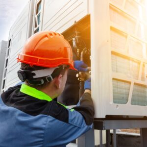 hvac technician repairing commercial unit