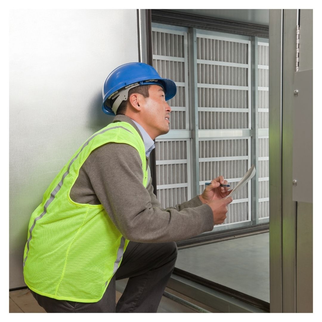 HVAC technician assessing space