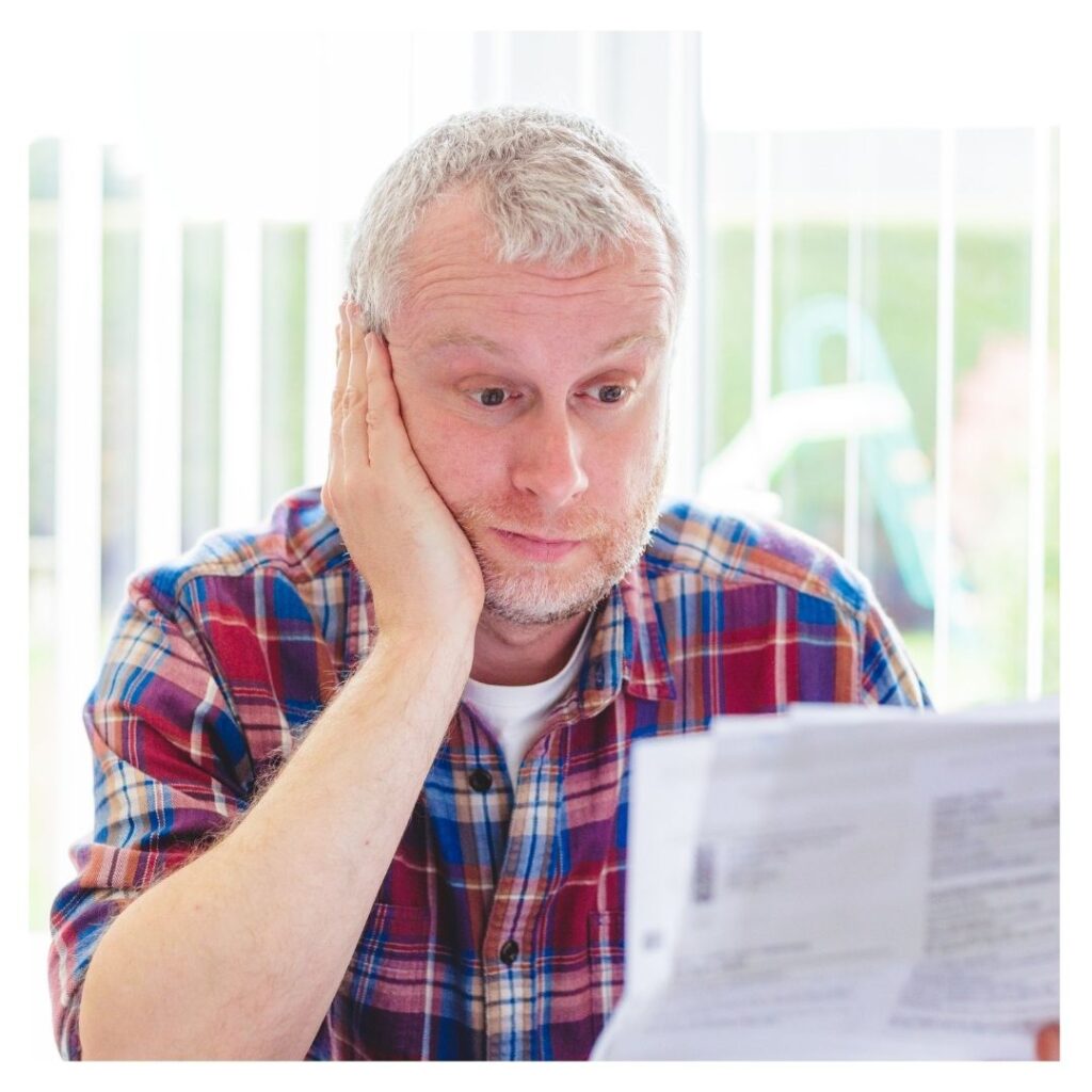a man looking at his bills