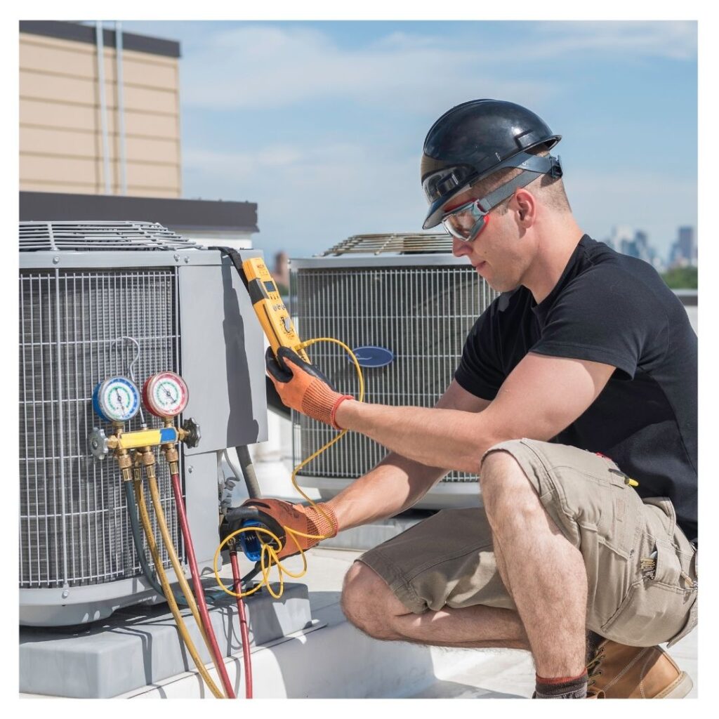 An HVAC contractor checking an ac unit