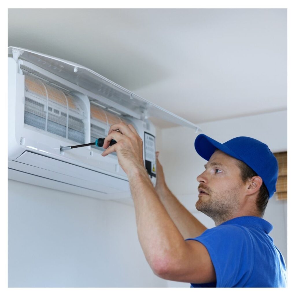 An HVAC contractor fixing an ac unit