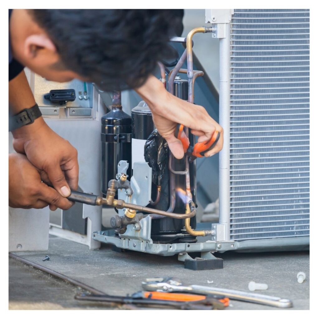 An HVAC contractor fixing a unit