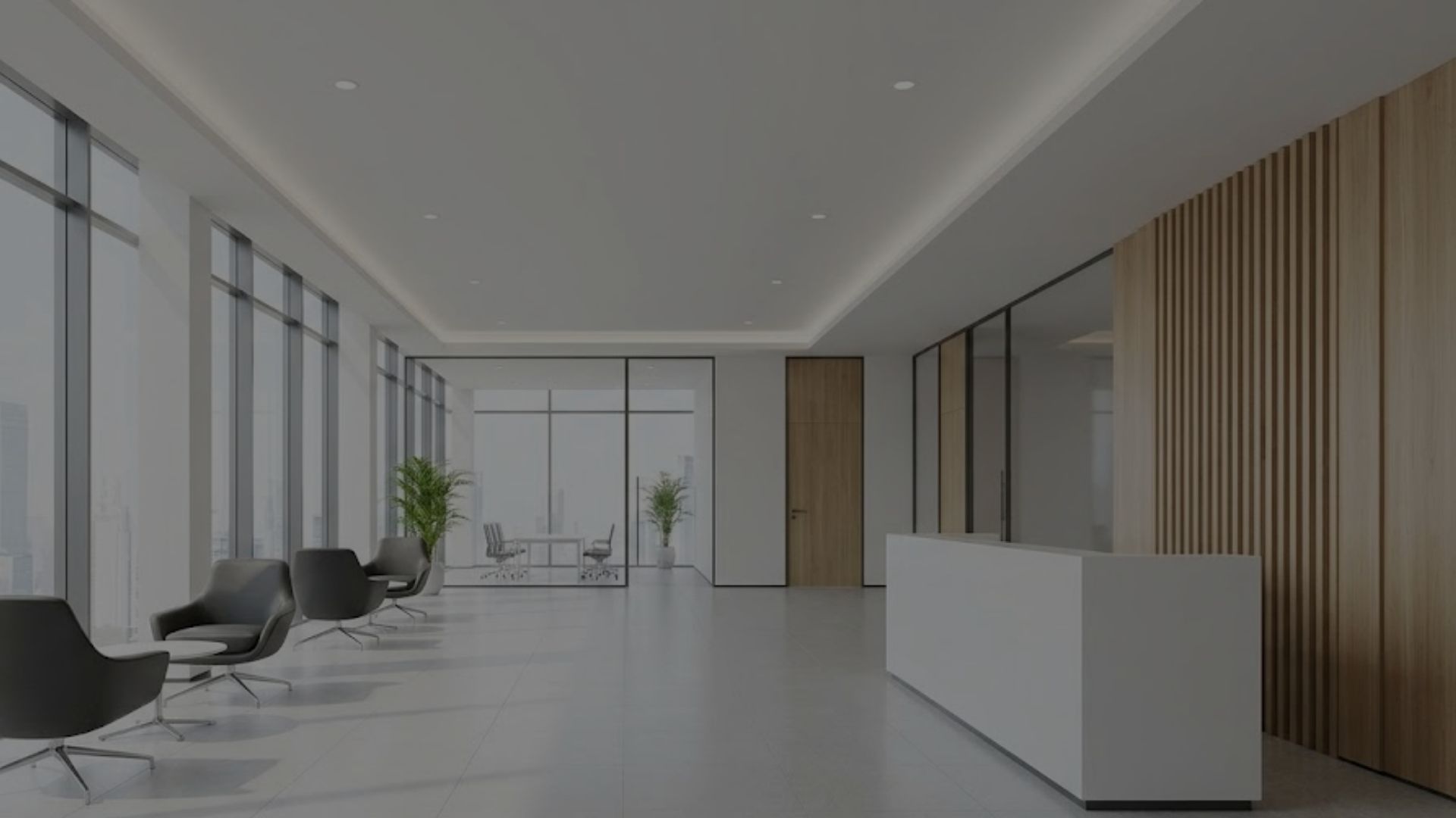 A clean, brightly lit modern commercial office lobby welcomes guests with natural light.