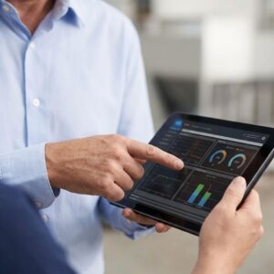 A consultant points to a digital tablet screen displaying detailed HVAC performance data and graphs.